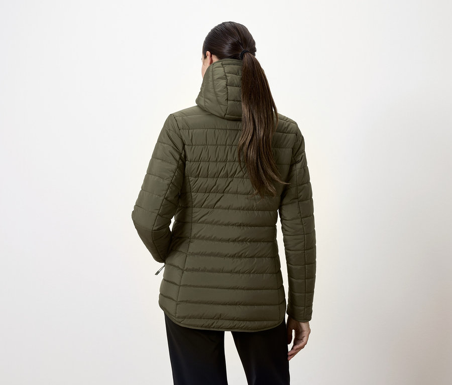 Widok z tyłu kobiety w oliwkowozielonej kurtce puchowej i czarnych spodniach.