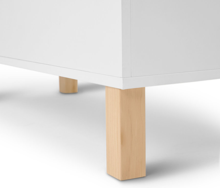Szczegółowy widok białego mebla z jasnymi drewnianymi nogami.