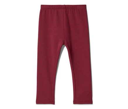 Ciemnoczerwone legginsy dziecięce, leżące płasko na białym tle.