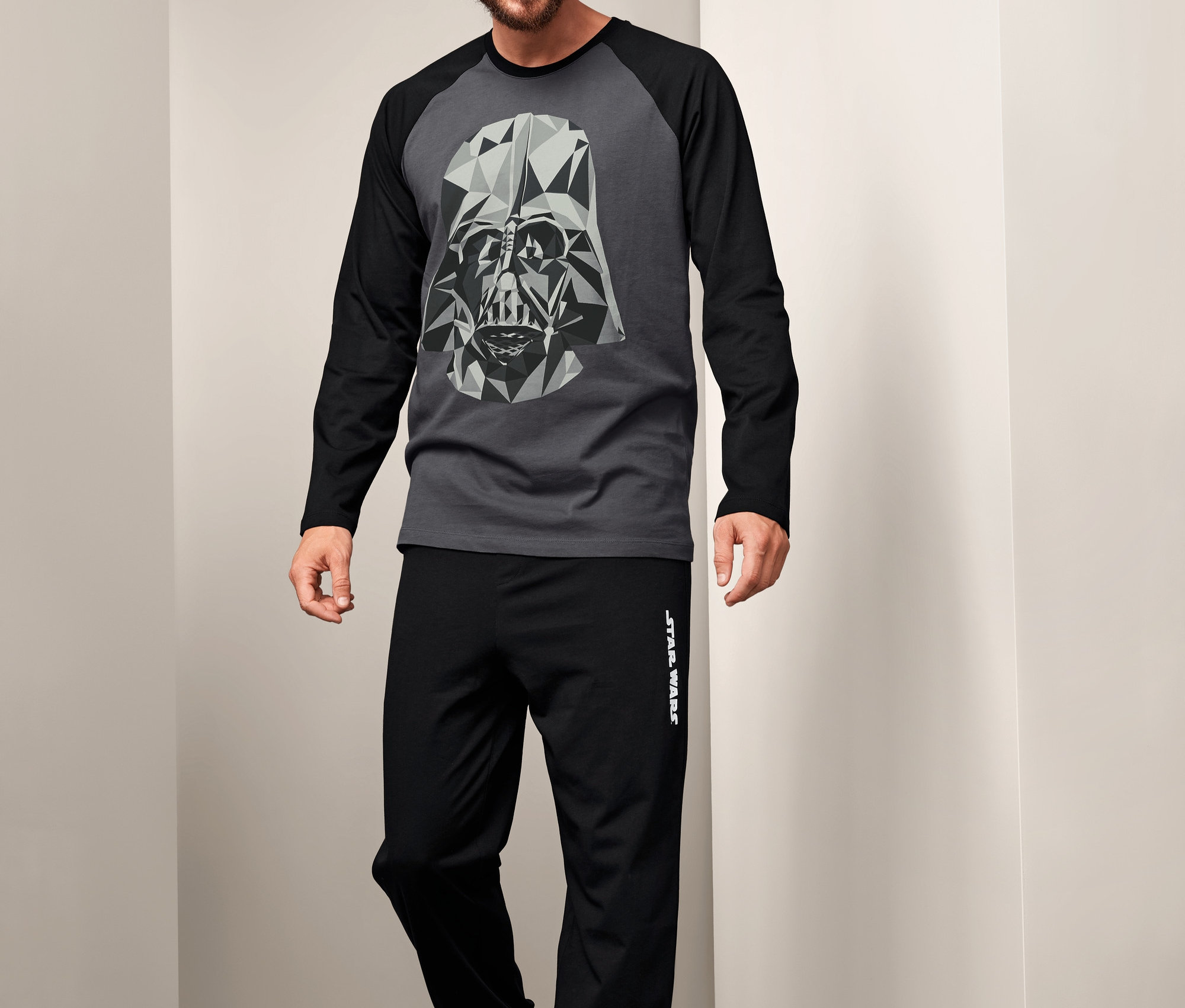 Mężczyzna ma na sobie piżamę »Star Wars« z grafiką Dartha Vadera.