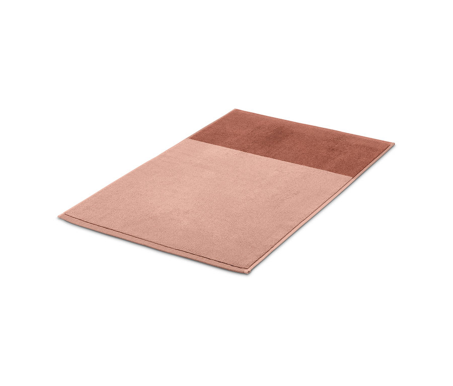 Różowo-rdzawy żakardowy dywanik pod prysznic.