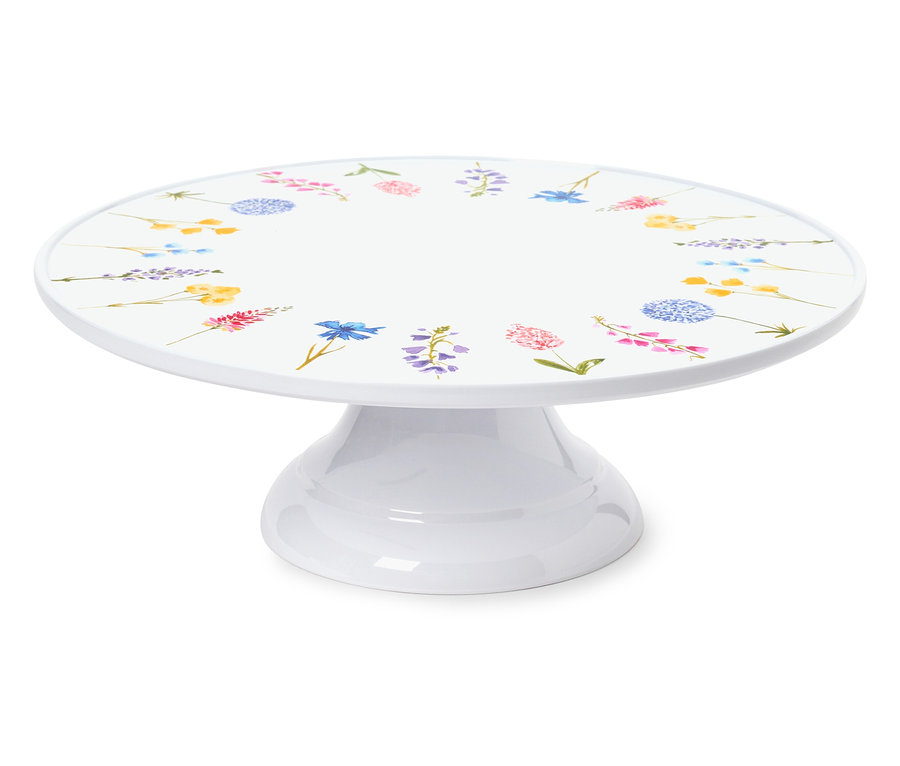 Biały stojak na ciasto z kwiatowym wzorem.