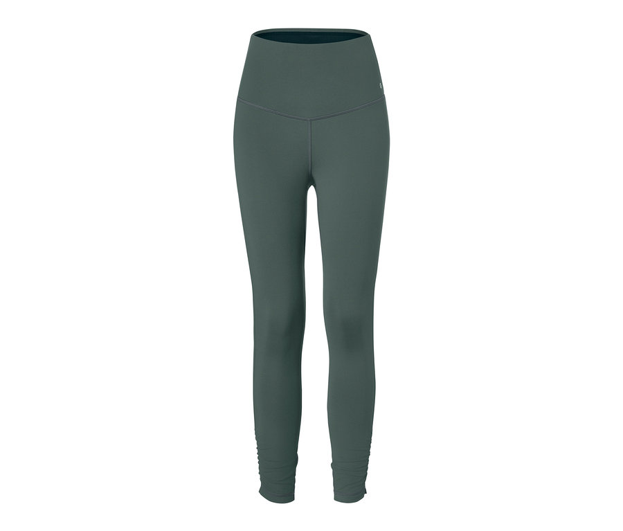 Zielone legginsy sportowe modelujące sylwetkę na białym tle.