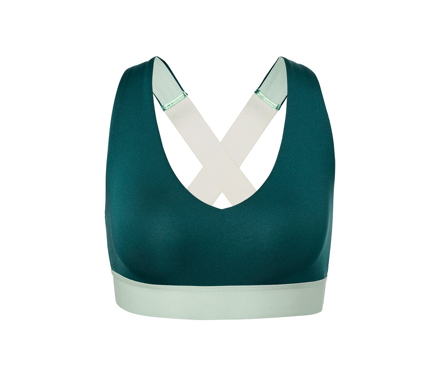 Zielony stanik sportowy z krzyżowanymi ramiączkami.