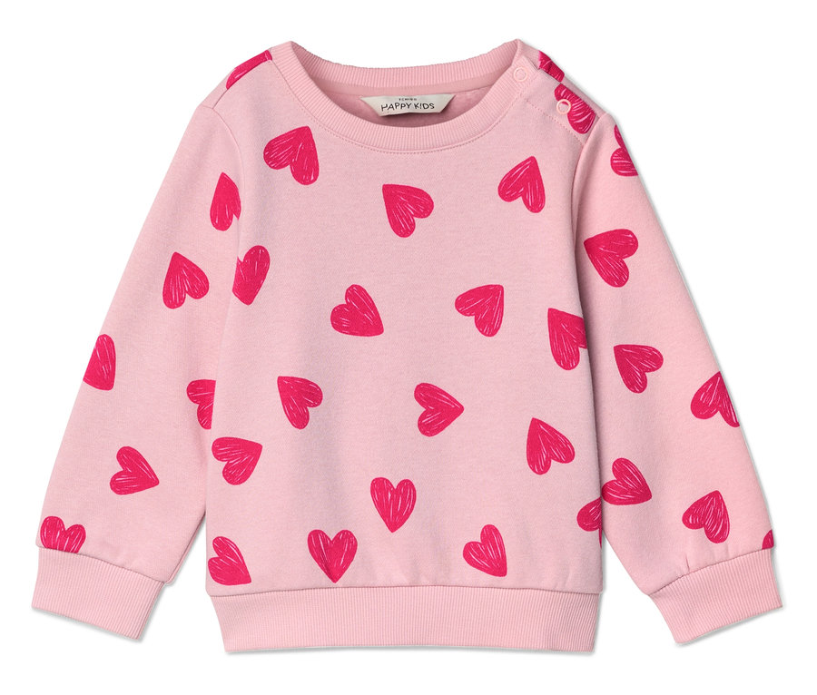 Jasnoróżowa bluza z czerwonym wzorem w serca leży płasko na białej powierzchni.