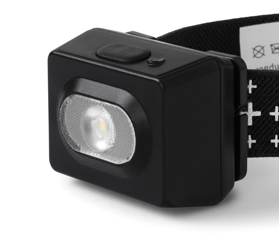Szczegółowe zdjęcie czarnej latarki czołowej.