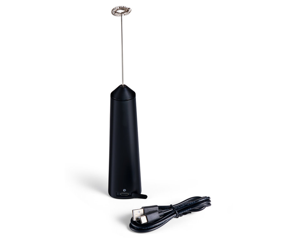 Czarny akumulatorowy spieniacz do mleka i kabel do ładowania leżą na białej powierzchni.