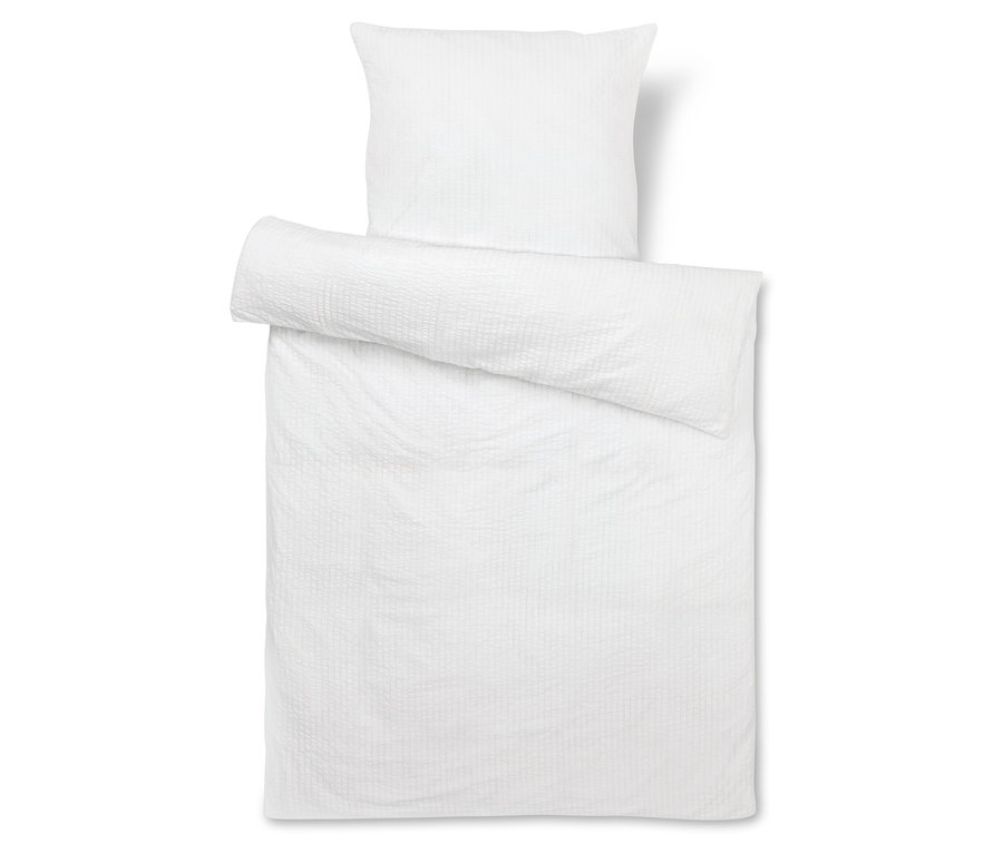 Biała pościel z poduszką.