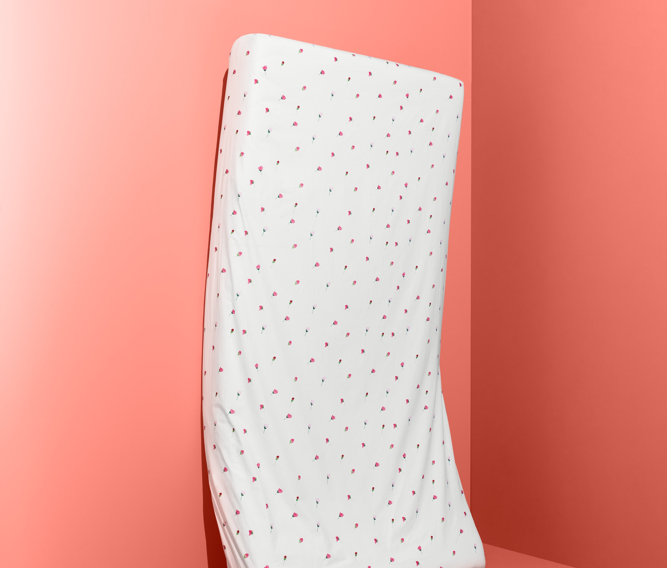 Białe prześcieradło w czerwone kropki oparte o ścianę.