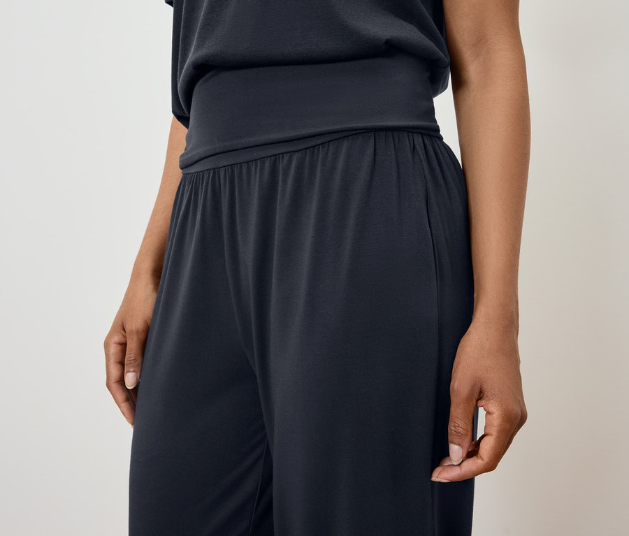 Kobieta ma na sobie czarną piżamę.