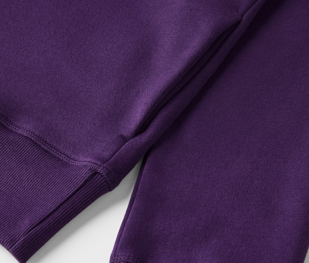Zbliżenie na fioletową bluzę dresową ze ściągaczem.