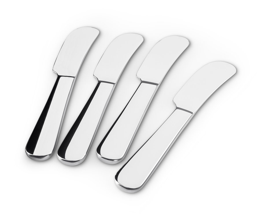 Cztery noże do masła leżą na białym tle.