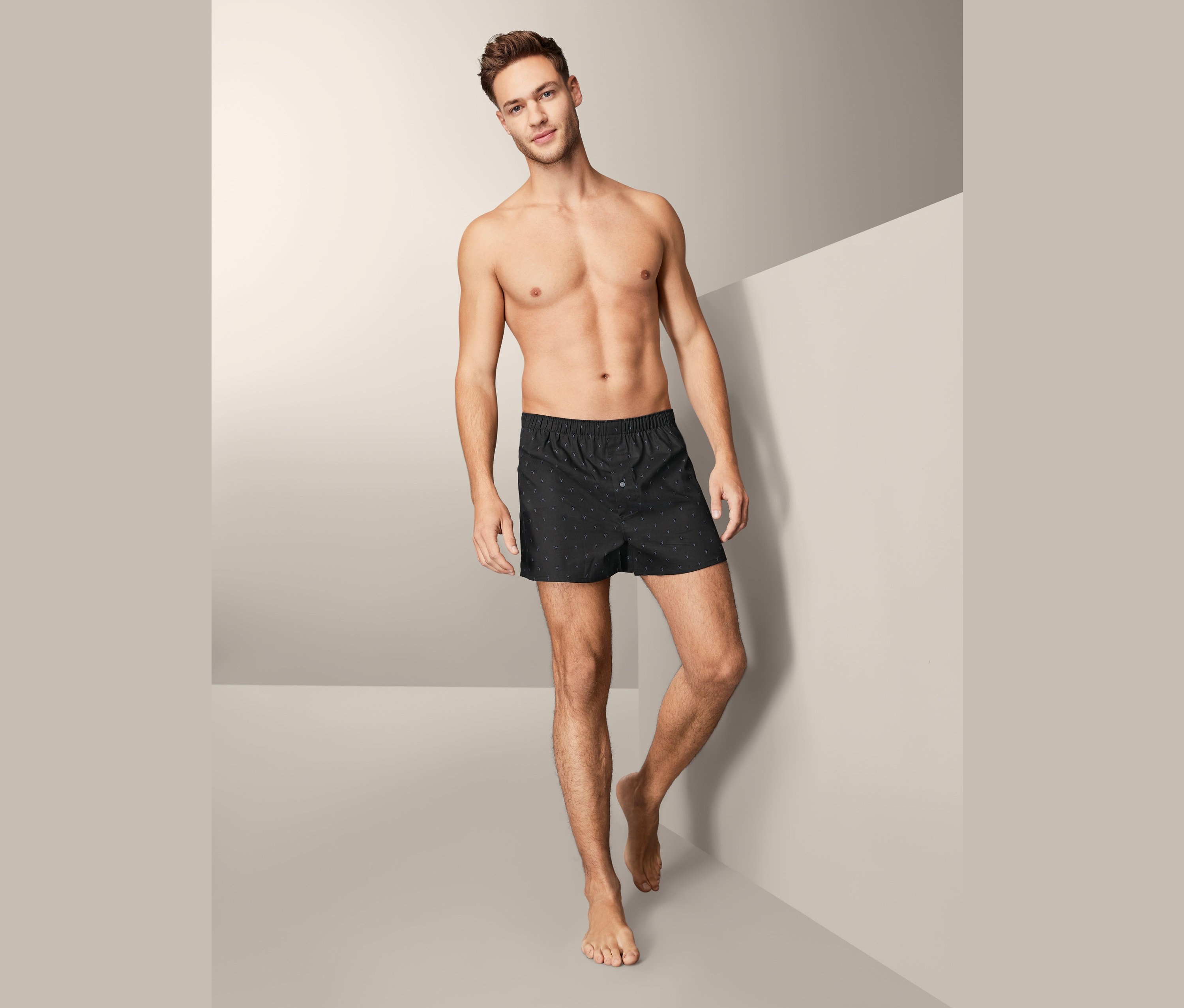 Mężczyzna pozuje bez koszuli, ubrany w bokserki męskie z lekkiej flaneli, 2 pary.