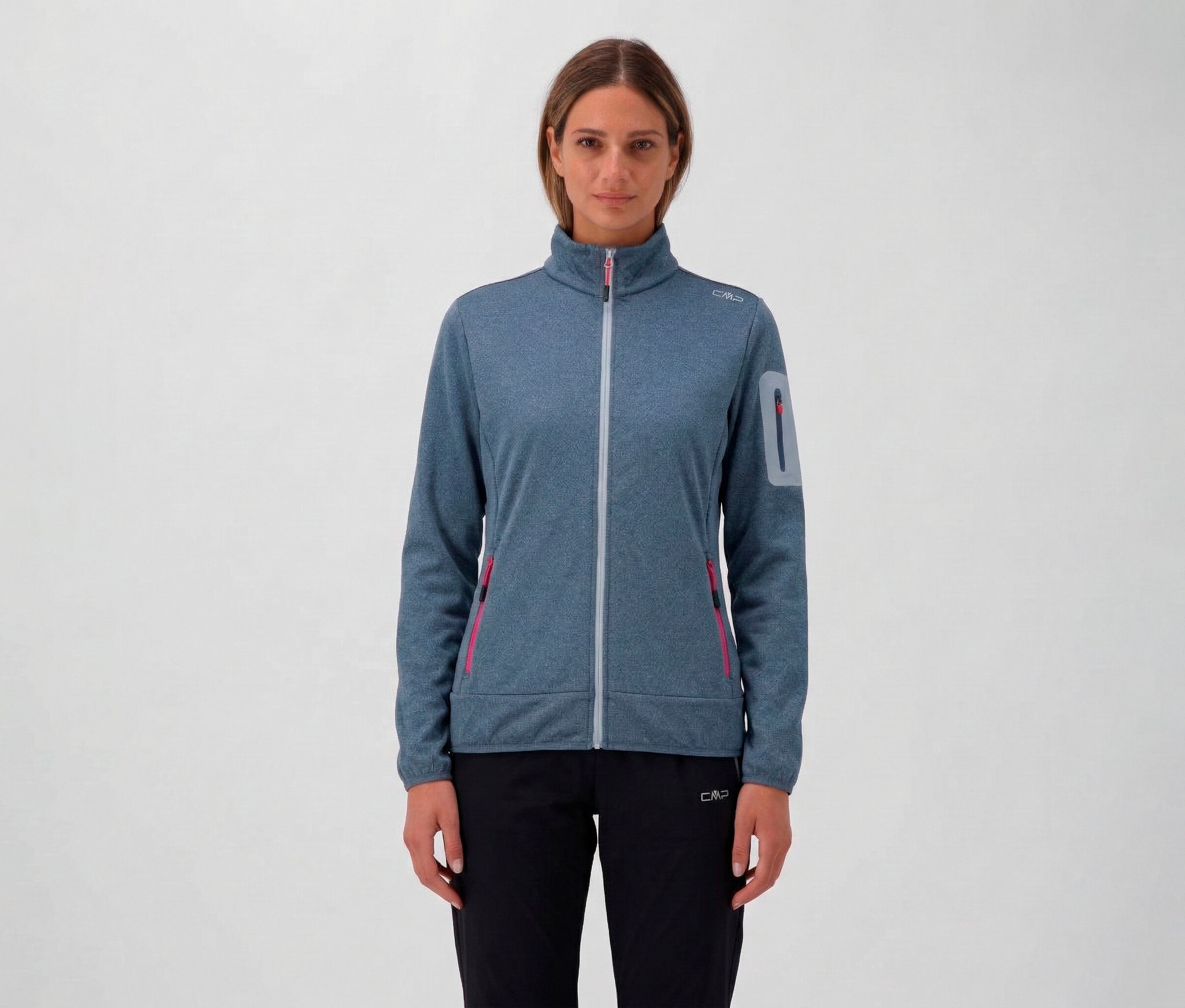 Kobieta w czarnych spodniach i rozpinanej bluzie CMP z zamkiem błyskawicznym i kieszeniami.