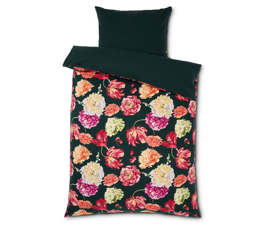 Pościel we wzory kwiatowe z ciemnozielonym obramowaniem i poduszką.