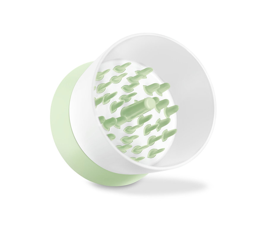 Rozdrabniacz do warzyw z białym wnętrzem i jasnozielonym wykończeniem.