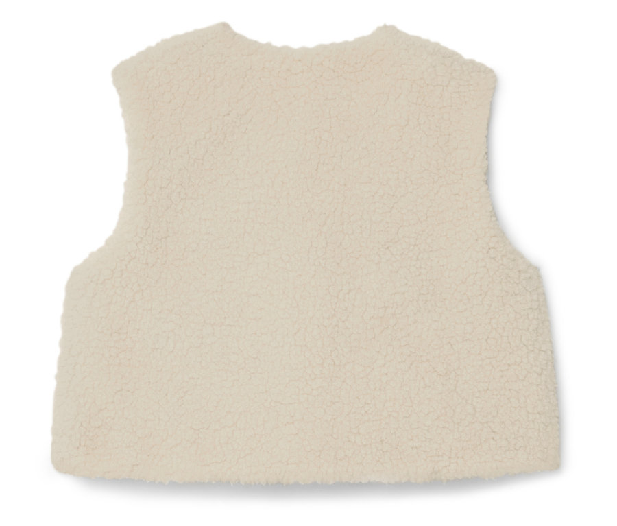 Zdjęcie z bliska kremowej kamizelki polarowej bez rękawów.