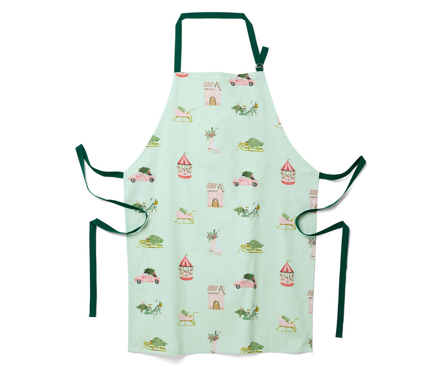 Jasnozielony fartuch z świątecznym wzorem domów, samochodów, sanek i karuzel.